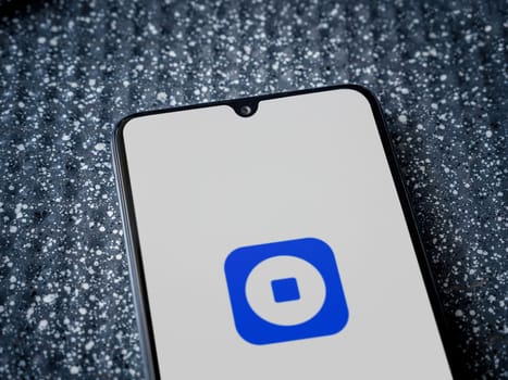 Lod, Israel - July 16,2023: Coinbase Wallet app launch screen on smartphone on metallic background. Close up top view flat lay.