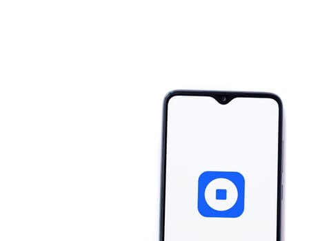 Lod, Israel - July 16,2023: Coinbase Wallet app launch screen on smartphone on white background. Top view flat lay with copy space.