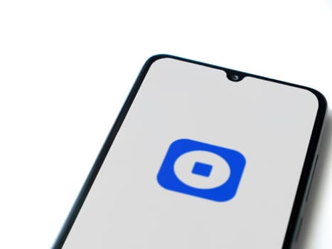 Lod, Israel - July 16,2023: Coinbase Wallet app launch screen on smartphone on white background. Top view flat lay with copy space.