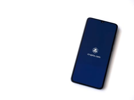 Lod, Israel - July 16,2023: Crypto.com app launch screen on smartphone on white background. Top view flat lay with copy space.