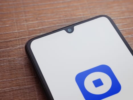 Lod, Israel - July 16,2023: Coinbase Wallet app launch screen on smartphone on wooden background. Top view flat lay with copy space.