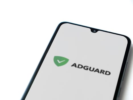 Lod, Israel - July 16,2023: AdGuard app launch screen on smartphone on white background. Top view flat lay with copy space.