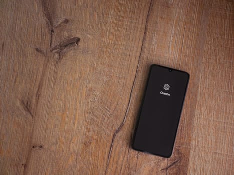 Lod, Israel - July 16,2023: ChatOn app launch screen on smartphone on wooden background. Top view flat lay with copy space.