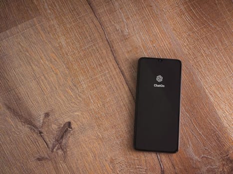 Lod, Israel - July 16,2023: ChatOn app launch screen on smartphone on wooden background. Top view flat lay with copy space.