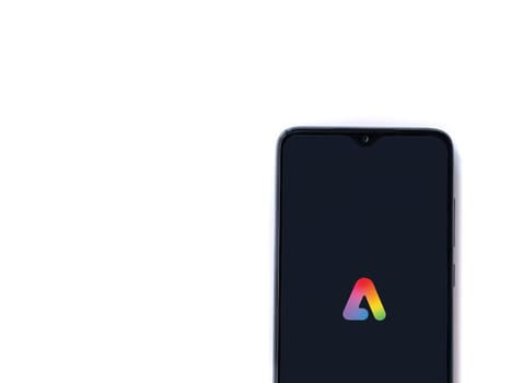 Lod, Israel - July 16,2023: Adobe Express - Graphic Design app launch screen on smartphone on white background.. Top view flat lay with copy space.
