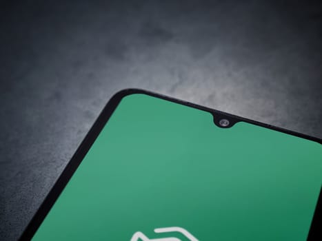 Lod, Israel - July 16,2023: Adam Ai app launch screen on smartphone on dark marble stone background. Top view flat lay with copy space.