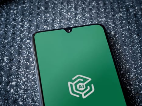 Lod, Israel - July 16,2023: Adam Ai app launch screen on smartphone on metallic background. Close up top view flat lay.