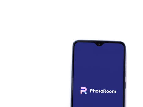 Lod, Israel - July 16,2023: PhotoRoom Studio Photo Editor app launch screen on smartphone on white background.. Top view flat lay with copy space.