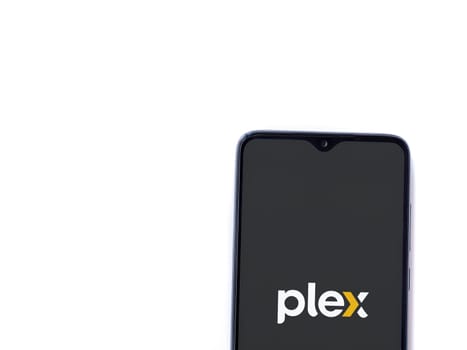 Lod, Israel - July 16,2023: Plex app launch screen on smartphone on white background. Top view flat lay with copy space.