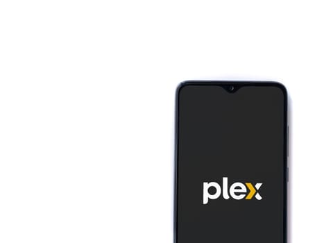 Lod, Israel - July 16,2023: Plex app launch screen on smartphone on white background. Top view flat lay with copy space.