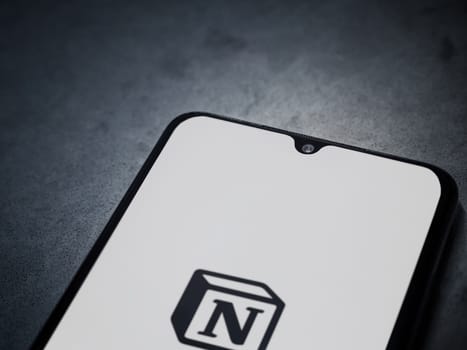 Lod, Israel - July 16,2023: Notion app launch screen on smartphone on dark marble stone background. Top view flat lay with copy space.