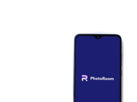 Lod, Israel - July 16,2023: PhotoRoom Studio Photo Editor app launch screen on smartphone on white background.. Top view flat lay with copy space.