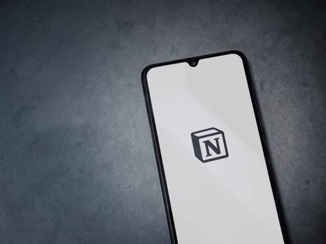 Lod, Israel - July 16,2023: Notion app launch screen on smartphone on dark marble stone background. Top view flat lay with copy space.