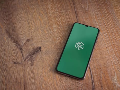 Lod, Israel - July 16,2023: Adam Ai app launch screen on smartphone on wooden background. Top view flat lay with copy space.