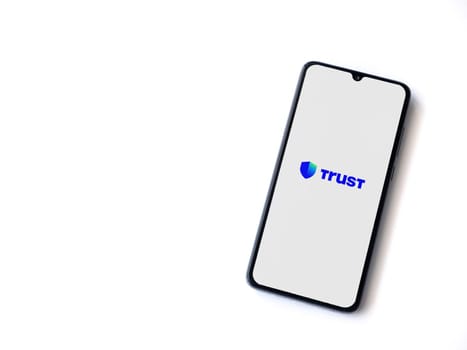 Lod, Israel - July 16,2023: Trust Wallet app launch screen on smartphone on white background. Top view flat lay with copy space.