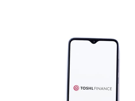 Lod, Israel - July 16,2023: Toshl Finance app launch screen on smartphone on white background. Top view flat lay with copy space.