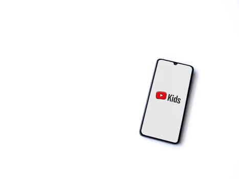 Lod, Israel - July 16,2023: YouTube Kids app launch screen on smartphone on white background. Top view flat lay with copy space.