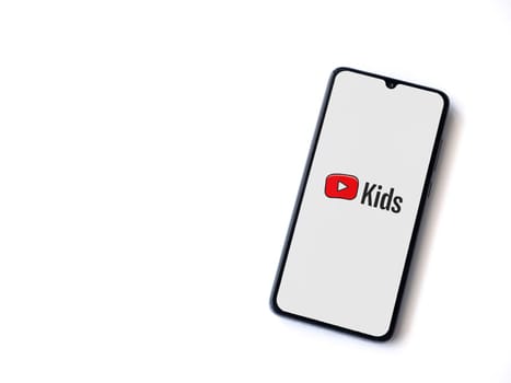 Lod, Israel - July 16,2023: YouTube Kids app launch screen on smartphone on white background. Top view flat lay with copy space.