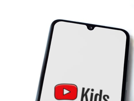 Lod, Israel - July 16,2023: YouTube Kids app launch screen on smartphone on white background. Top view flat lay with copy space.