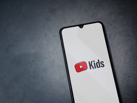 Lod, Israel - July 16,2023: YouTube Kids app launch screen on smartphone on dark marble stone background. Top view flat lay with copy space.