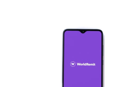 Lod, Israel - July 16,2023: WorldRemit app launch screen on smartphone on white background. Top view flat lay with copy space.