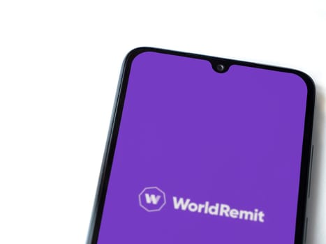 Lod, Israel - July 16,2023: WorldRemit app launch screen on smartphone on white background. Top view flat lay with copy space.