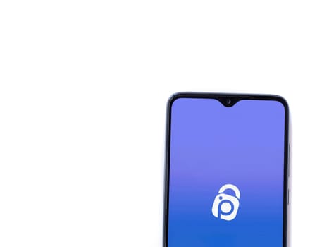 Lod, Israel - July 16,2023: IDrive Photo Backup app launch screen on smartphone on white background. Top view flat lay with copy space.