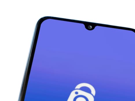 Lod, Israel - July 16,2023: IDrive Photo Backup app launch screen on smartphone on white background. Top view flat lay with copy space.