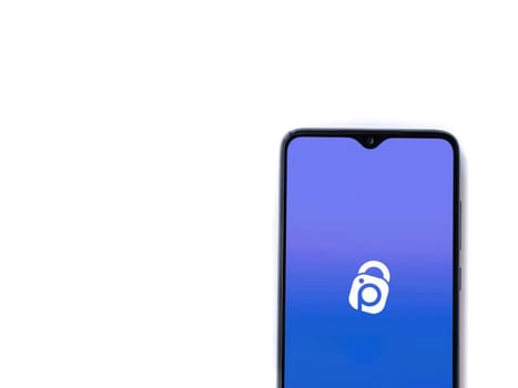 Lod, Israel - July 16,2023: IDrive Photo Backup app launch screen on smartphone on white background. Top view flat lay with copy space.