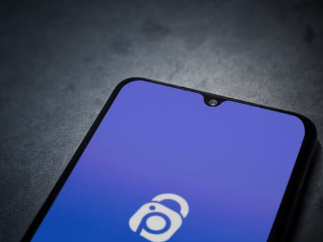 Lod, Israel - July 16,2023: IDrive Photo Backup app launch screen on smartphone on dark marble stone background. Top view flat lay with copy space.