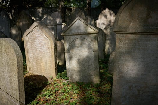 old weathered gravestones on a historical Jewish cemetery in Prague-Žižkov district