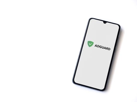 Lod, Israel - July 16,2023: AdGuard app launch screen on smartphone on white background. Top view flat lay with copy space.