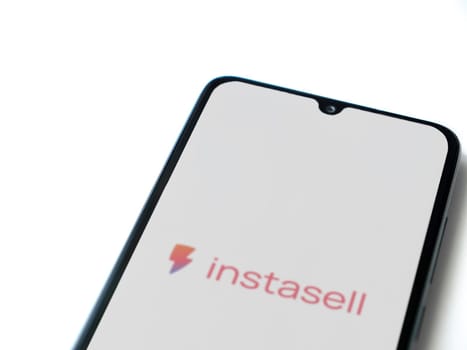 Lod, Israel - July 16,2023: Instasell app launch screen on smartphone on white background. Top view flat lay with copy space.