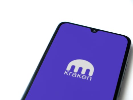 Lod, Israel - July 16,2023: Kraken app launch screen on smartphone on white background. Top view flat lay with copy space.