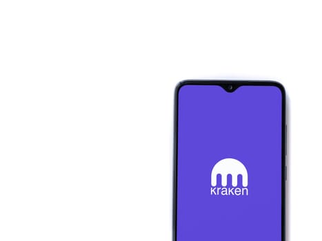 Lod, Israel - July 16,2023: Kraken app launch screen on smartphone on white background. Top view flat lay with copy space.