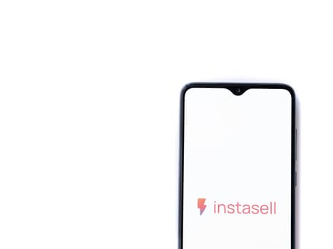 Lod, Israel - July 16,2023: Instasell app launch screen on smartphone on white background. Top view flat lay with copy space.