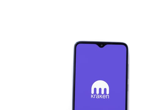Lod, Israel - July 16,2023: Kraken app launch screen on smartphone on white background. Top view flat lay with copy space.