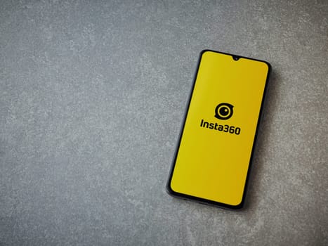 Lod, Israel - July 16,2023: Insta360 app launch screen on smartphone on ceramic stone background.. Top view flat lay with copy space.