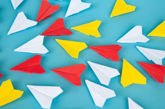 Low view of yellow paper plane origami leading white paper planes. With copy space for text