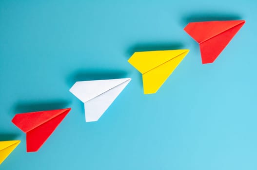 Top view of yellow paper airplanes with space for text.