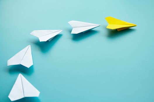 Top view of yellow paper airplanes with space for text.