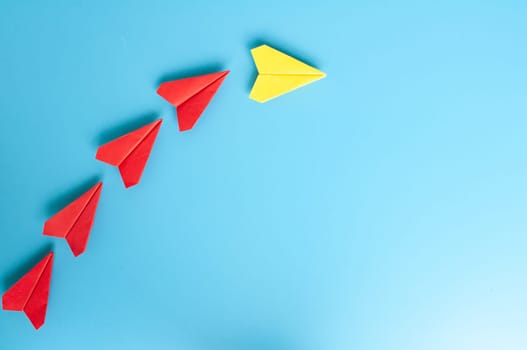 Top view of yellow paper airplanes with space for text.