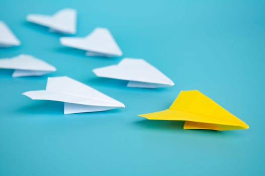 Top view of yellow paper airplanes with space for text.