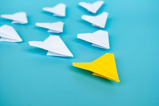 Top view of yellow paper airplanes with space for text.