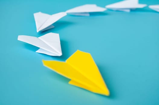 Top view of yellow paper airplanes with space for text.