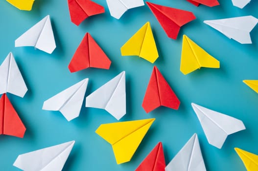 Top view of yellow paper airplanes with space for text.