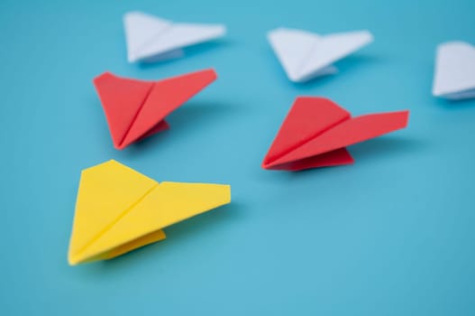 Top view of yellow paper airplanes with space for text.