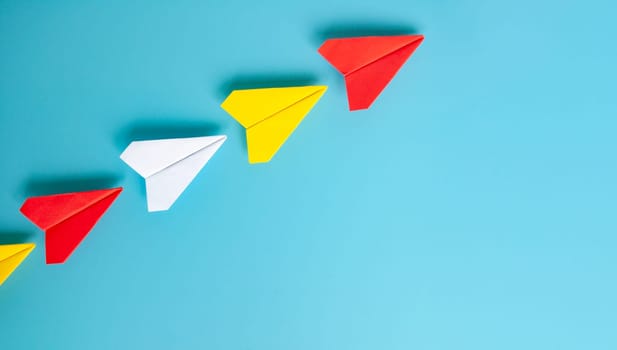 Top view of yellow paper airplanes with space for text.