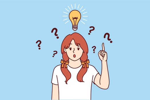 Little girl with light bulb above head says eureka and points up indicating presence of idea to solve problem. Child prodigy comes up with brilliant idea and opens mouth in surprise