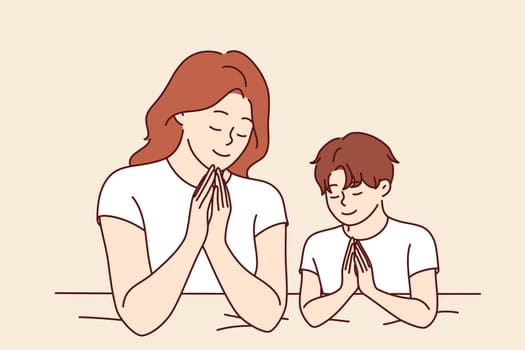 Mom prays with son before bed, asking god to save from problems and teaching child to religious lifestyle. Woman and boy praying making prayer gesture and closing eyes to ask god for help